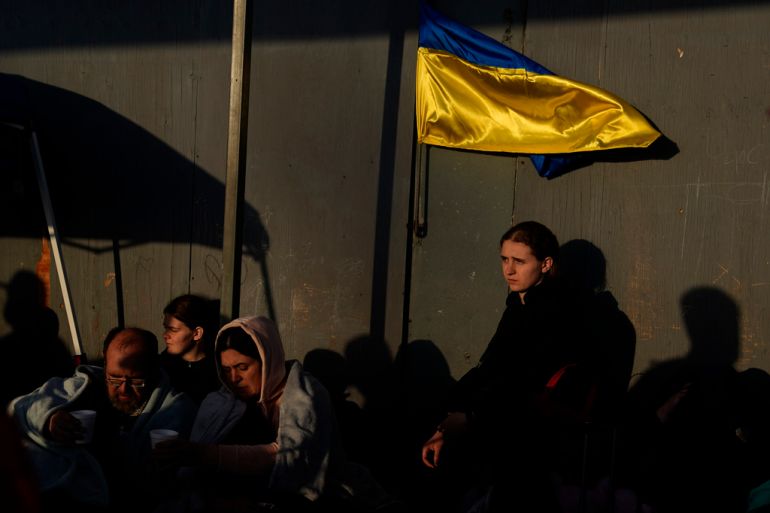 A Ukrainian refugee waits with others near the US border with Mexico.