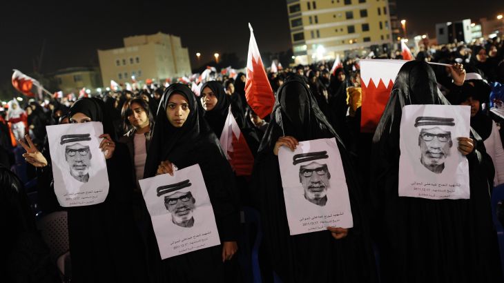 Bahraini Shia women holding pictures of a man who was allegedly killed by security forces a week before, demonstrate in an anti-government rally in the village of Muqsha, west of Manama on December 24, 2011.
