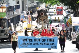 Extinction Rebellion protesters push a giant puppet depicting a burning koala in Brisbane, Australia