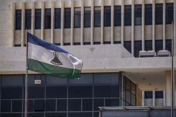 picture taken in Maseru, on January 31, 2020 shows the flag of Lesotho outside the Parliament building. [Michele Spatari / AFP]