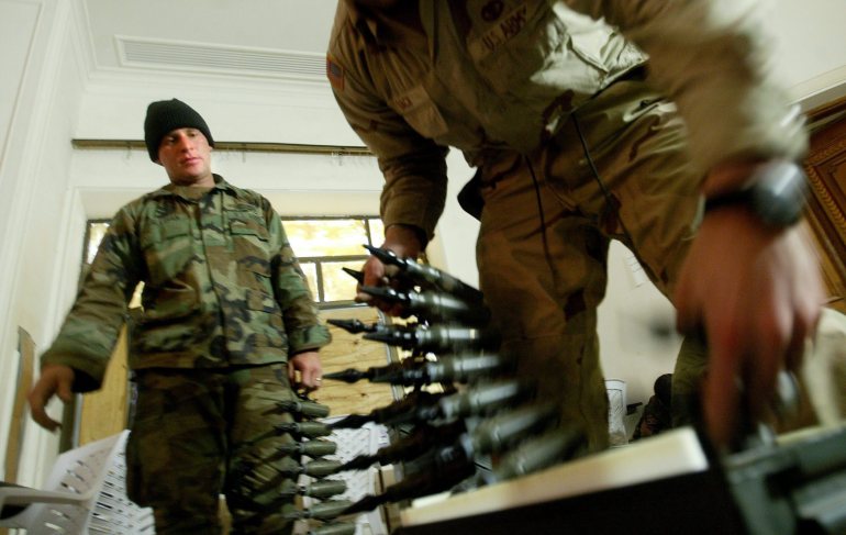 US soldiers pack up 25mm depleted uranium rounds into ammunition cases at a base in Tikrit, Iraq, in 2004