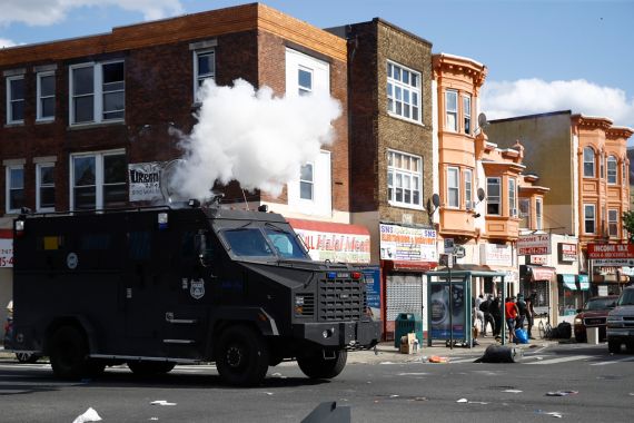 A police van fires tear gas at a crowd in a Philadelphia street.