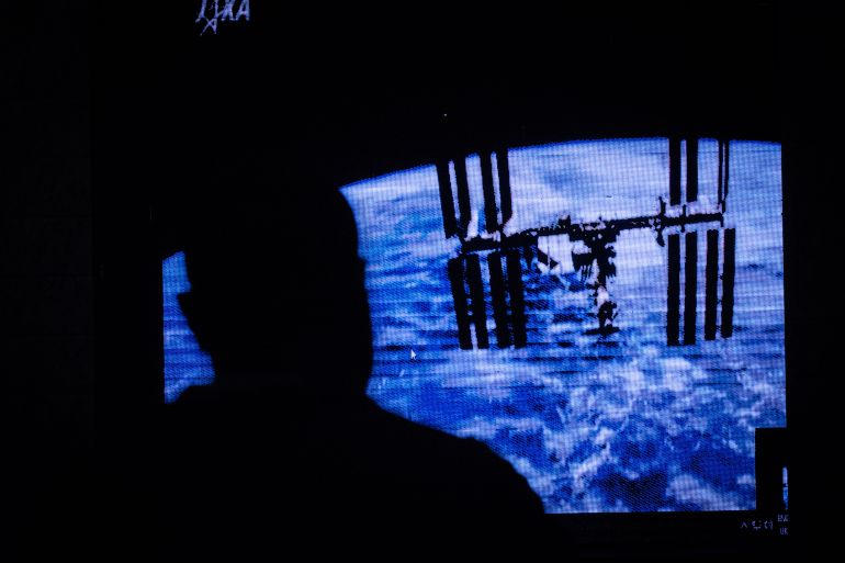 An image of the International Space Station (ISS) is projected during the public viewing of deployment of Kenya’s first nano satellite (CubeSat) from the ISS at the University of Nairobi in Nairobi on May 11, 2018 [Yasuyoshi Chiba/AFP]
