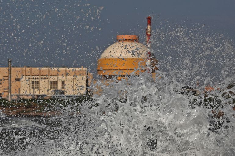Sea waves hit the rocks as Kudankulam nuclear power project plant is seen in the background in the southern Indian state of Tamil Nadu