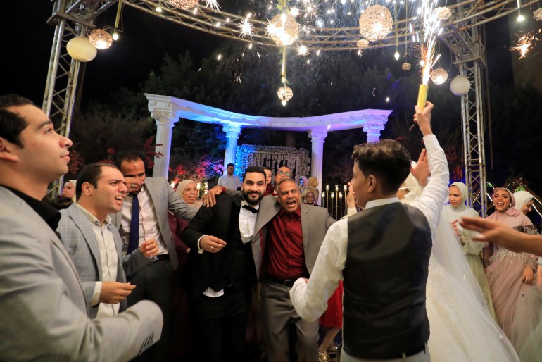 Groom Moustafa Khaled dances with his father and guests