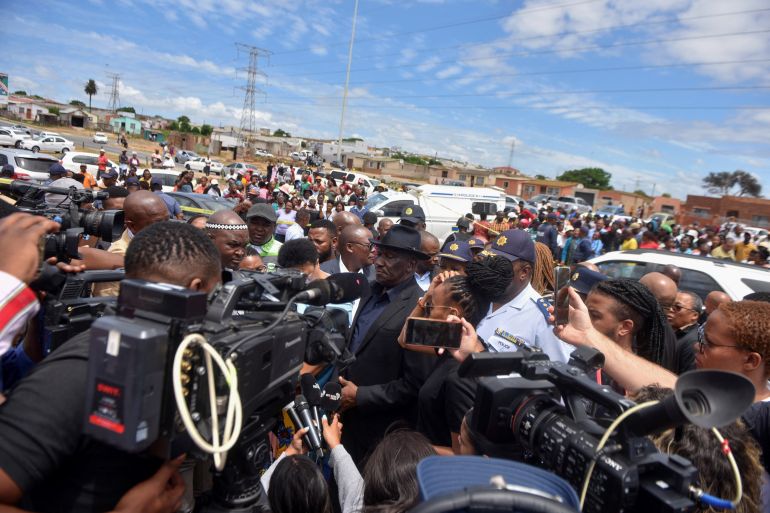 South African Police Minister Bheki Cele and National Police commissioner Fannie Masemola visit the scene of a mass shooting at a birthday party in Kwazakhele, Gqeberha, South Africa. January 30, 2023