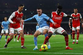 Arsenal's William Saliba and Bukayo Saka in action with Manchester City's Phil Foden