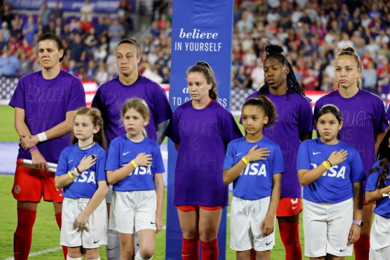 Canadian women national team members wear purple protest shirts with the words, 'Enough is enough' on them ahead of a tournament game against the US