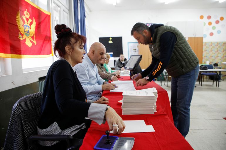 A man registers himself at a polling station during the run-off presidential election in Podgorica, Montenegro