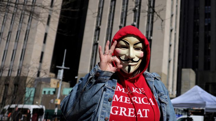 A supporter of former U.S. President Donald Trump flashes the white power gesture near the Manhattan Criminal Court, after Donald Trump's indictment by a Manhattan grand jury following a probe into hush money paid to porn star Stormy Daniels, in New York City, U.S, April 3, 2023. REUTERS/Andrew Kelly