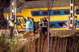 rescue operations underway following the derailment of a passenger train after it hit construction equipment on the track, in Voorschoten, Netherlands