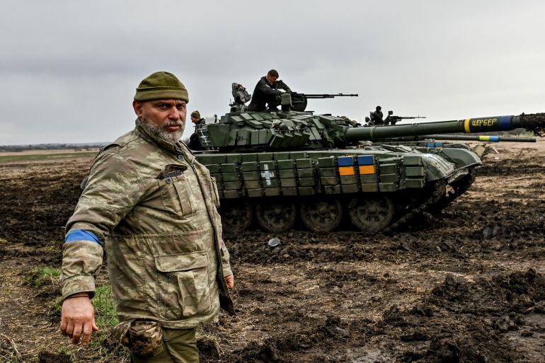 A Ukrainian service member stands next to a tank at a military training ground near a frontline, amid Russia's attack on Ukraine, in Zaporizhzhia region, Ukraine April 5, 2023