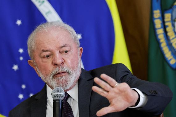 Brazil's President Lula with a Brazilian flag behind him