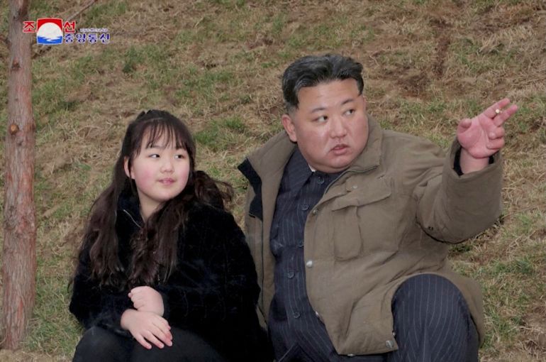 North Korean leader Kim Jong Un and his daughter Kim Ju Ae attend a test launch of a new solid-fuel intercontinental ballistic missile (ICBM)
