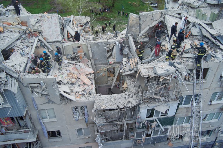 Rescuers work at the construction site of a residential building damaged by Russian military strikes in Sloviansk, Donetsk region, Ukraine, April 14, 2023. Press service of the Donetsk Regional Civil and Military Administration/Handout via Reuters Attention Editors - This image was provided by a third party. mandatory credit. Do not cover the sign. Resale prohibited. Not archived.