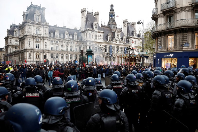French gendarmes stand in position during a demonstration in front of the Paris City Hall after French government's pension reform received the Constitutional Council's green light and can now be signed into law and enter into force swiftly, in Paris, France