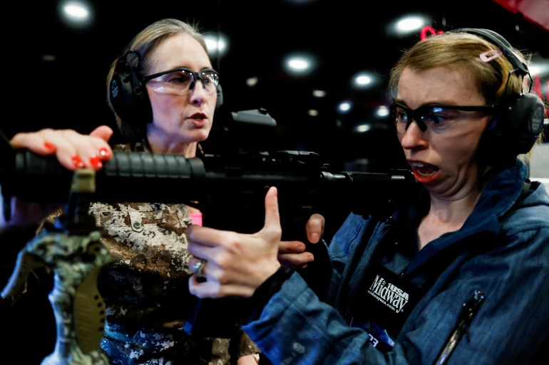A woman practising with a weapon at the NRA