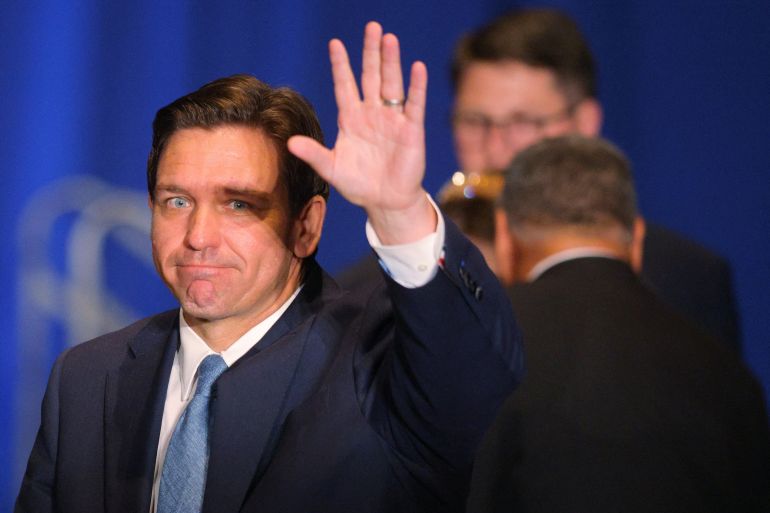 Florida Governor Ron DeSantis arrives to speak at the 2023 NHGOP Amos Tuck Dinner, waving as he enters
