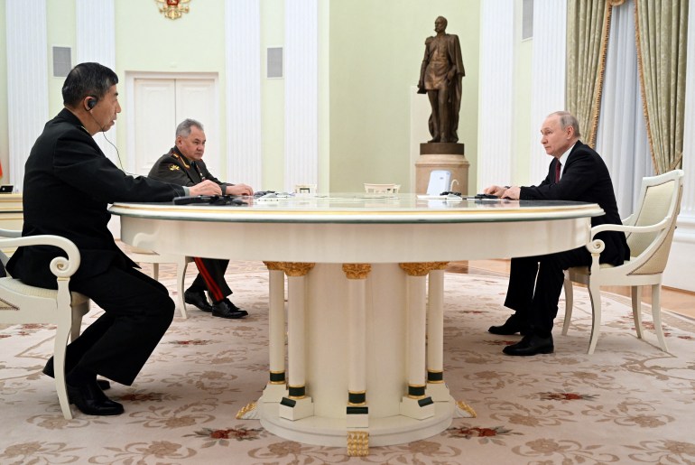 Russian President Vladimir Putin, Defence Minister Sergei Shoigu and Chinese Defence Minister Li Shangfu attend a meeting in Moscow, Russia, April 16, 2023. Sputnik/Pavel Bednyakov/Pool via REUTERS ATTENTION EDITORS - THIS IMAGE WAS PROVIDED BY A THIRD PARTY.