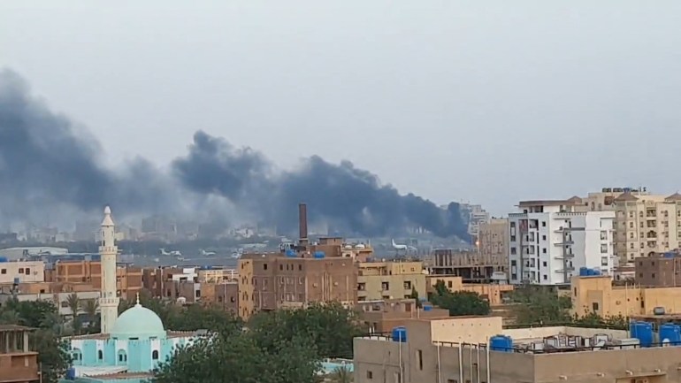 Smoke rises from the tarmac of Khartoum International Airport
