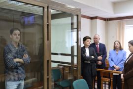Wall Street Journal reporter Evan Gershkovich, who was detained in March while on a reporting trip and charged with espionage, stands behind a glass wall of an enclosure for defendants, while U.S. Ambassador to Russia Lynne Tracy and lawyers Tatyana Nozhkina and Maria Korchagina appear in a courtroom before a hearing to consider an appeal against Gershkovich's detention, in Moscow, Russia April 18, 2023