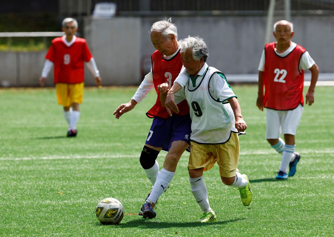 Red Star’s Takao Yokoyama (2nd to the left), 86, chases a ball against White Bear’s Kozo Ishida, 82, at the SFL (Soccer For Life) 80 League opening match