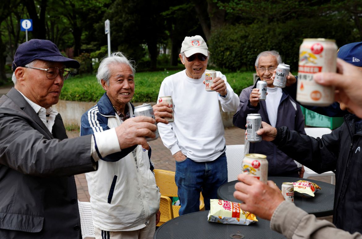 Red Star’s midfielder Mutsuhiko Nomura, 83, and his teammates toast with canned beers