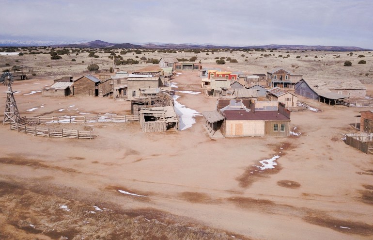 Aerial view of a desert movie set filled with small houses and buildings