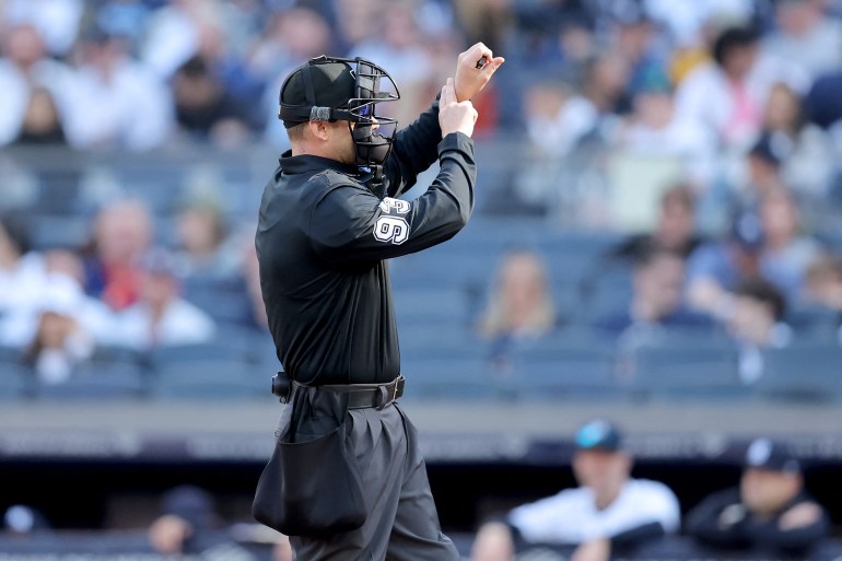 An umpire calls a pitch clock violation during a baseball game at New York's Yankee Stadium