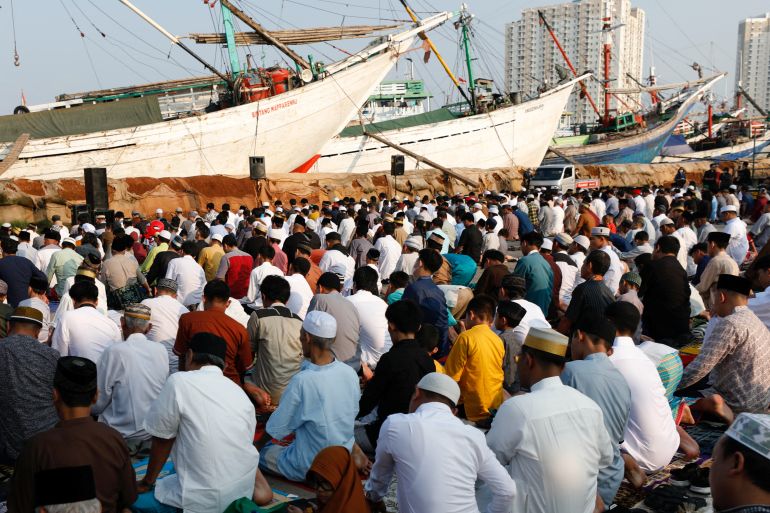 Muslim men attend mass prayers at the Sunda Kelapa port during Eid al-Fitr, marking the end of the holy fasting month of Ramadan in Jakarta, Indonesia, April 22, 2023. REUTERS/Ajeng Dinar Ulfiana