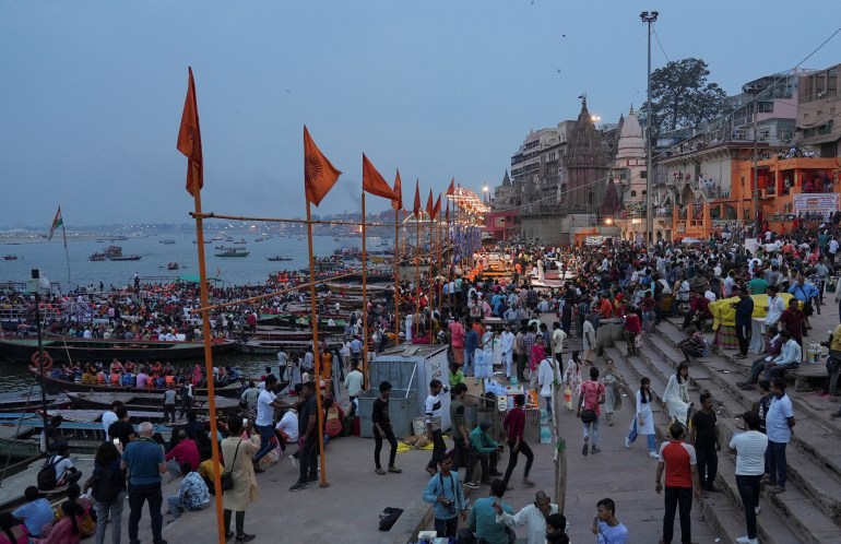 Spectators gather to watch the nightly "Ganga Aarti" prayer, in which several Hindu priests twirl flaming lanterns and censers over the Ganges, in Varanasi
