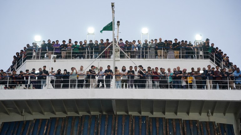 Civilians are seen onboard a Saudi commercial ship after being evacuated by Saudi Arabia