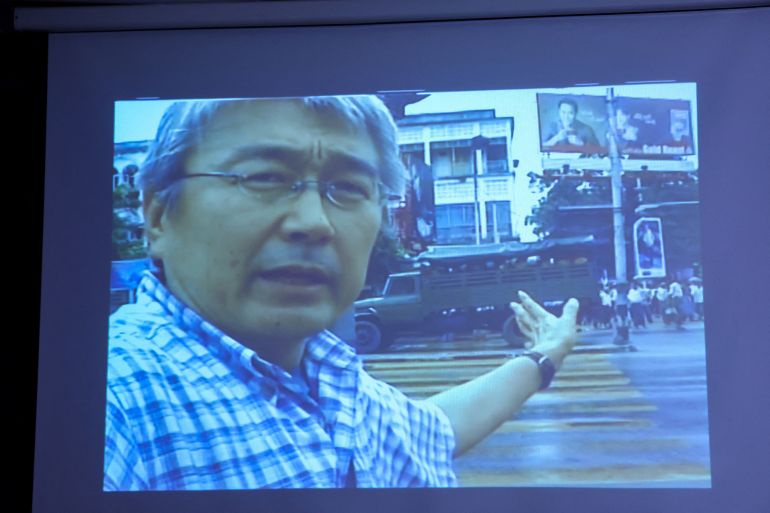 A screen shows unseen footage filmed by slain Japanese journalist Kenji Nagai, during an event to return his videocamera, lost during the coverage of the 2007 Saffron Revolution in Yangon, at the Foreign Correspondents' Club of Thailand in Bangkok, Thailand, April 26, 2023. REUTERS/Athit Perawongmetha