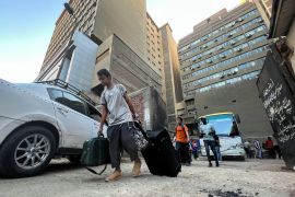 Sudanese and other nationals arrive by bus in the Egyptian capital, Cairo