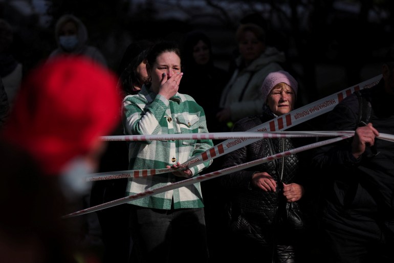 Family members and neighbours react at the site of a heavily damaged residential building hit by a Russian missile, amid Russia's attack on Ukraine, in the town of Uman, Cherkasy region, Ukraine April 28, 2023. REUTERS/Carlos Barria