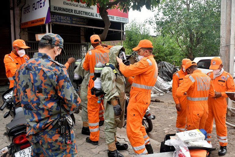 Members of National Disaster Response Force (NDRF) wear protective gear at the site of a gas leak in Ludhiana in the northern state of Punjab, India