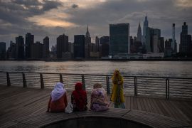 A group of muslim women stand before the Manhattan city skyline in Queens, New York on August 4, 2022. (Photo by Ed JONES / AFP)