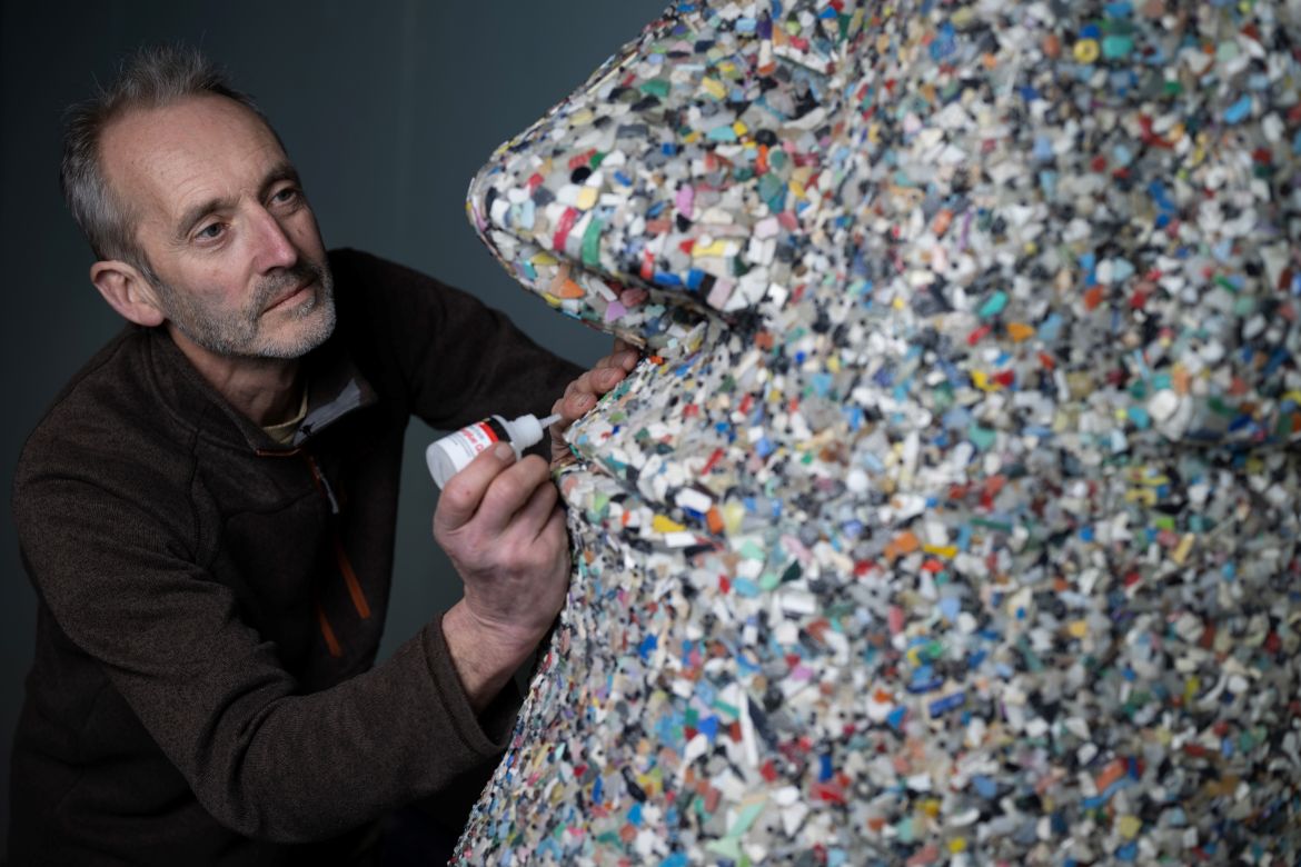Artist and environmental activist Rob Arnold, works on a sculpture called "A Lesson of history"