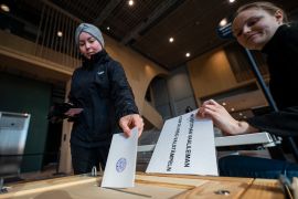 A voter casts her ballot at a polling centre during the general elections in Finland, in Helsinki [Jonathan Nackstrand/AFP]