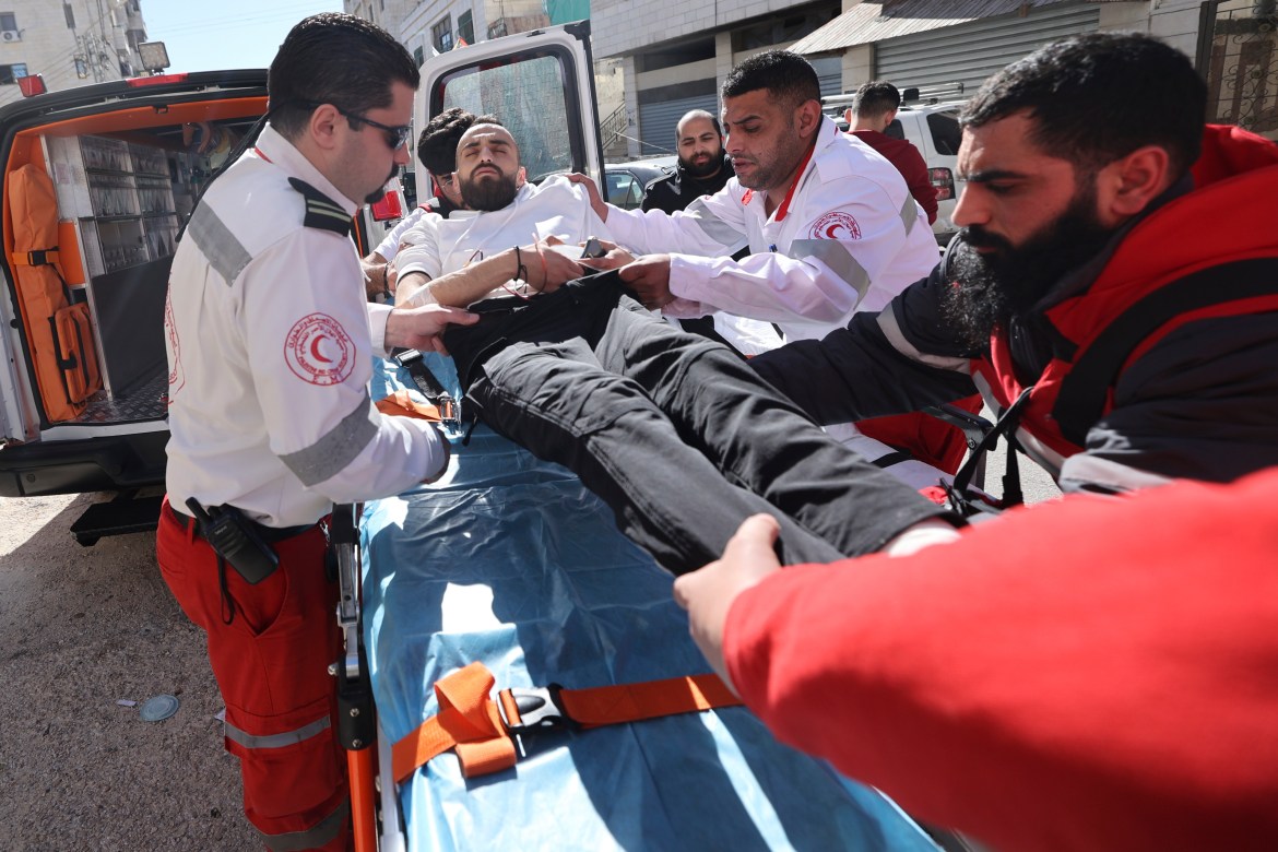 Red Crescent medics evacuate a wounded man following an Israeli raid in the city of Nablus