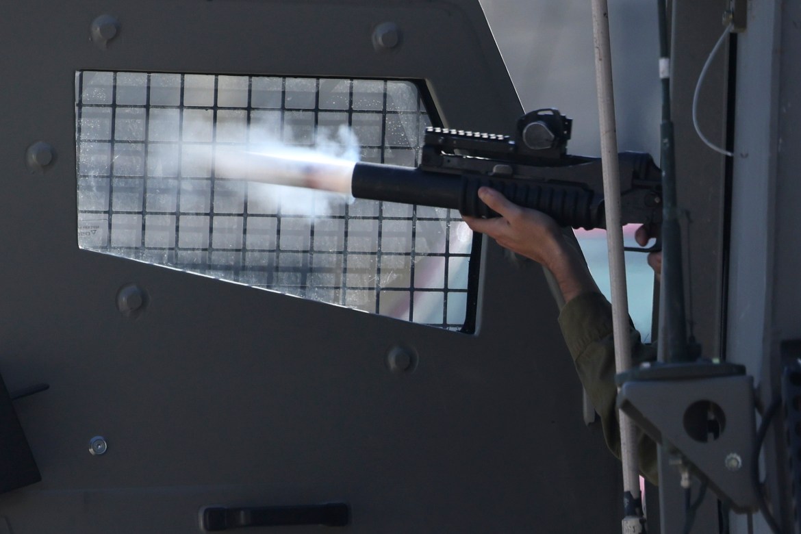 An Israeli soldier fires a projectile during clashes in the city of Nablus