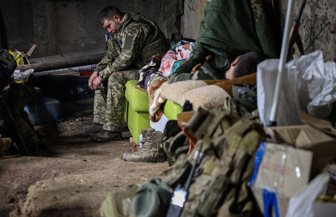 A Ukrainian servicemen rests in a bomb shelter at the frontline in the city of Bakhmut