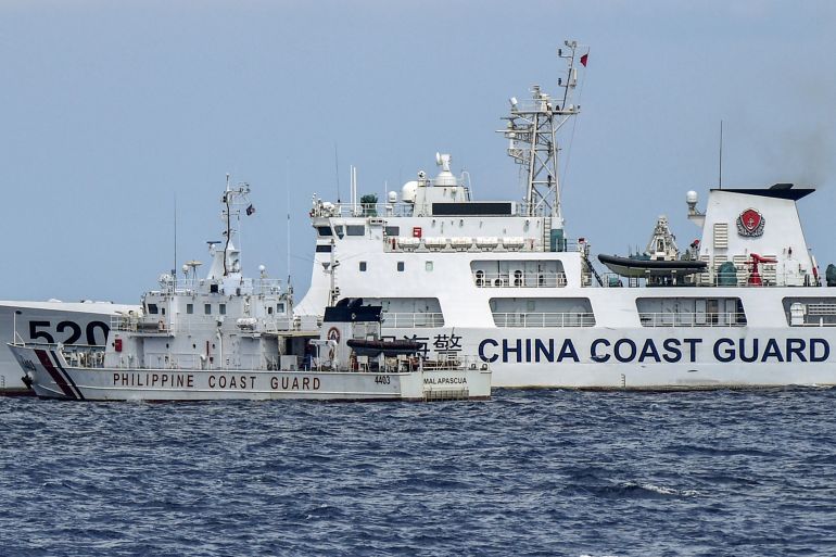 The Philippine coast guard vessel BRP Malapascua manoeuvres as a Chinese coast guard ship cuts its path at Second Thomas Shoal in the Spratly Islands in the disputed South China Sea.