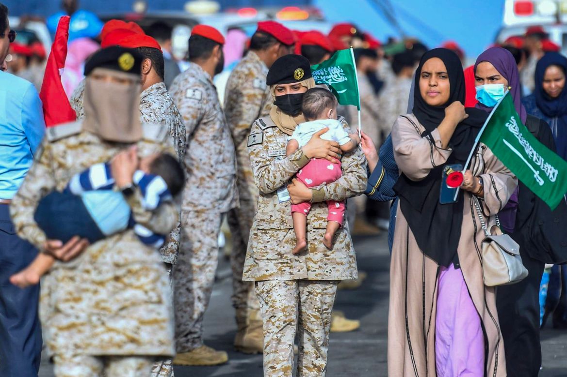 This handout picture provided by the Saudi Press Agency (SPA) shows Saudi Navy sailors helping evacuees upon arrival at King Faisal Navy Base in Jeddah