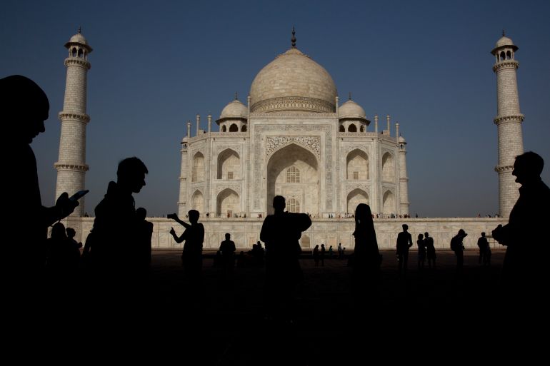 Indian and foreign tourist watch and take selfies of Taj Mahal, in Agra, India, Sunday, March 24, 2019. Clear skies and warm weather bring out crowds of people to visit the marble mausoleum on the bank of the Yamuna river. (AP Photo/Manish Swarup)