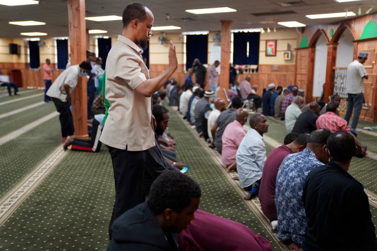 Yusuf Abdulle, standing, director of the Islamic Association of North America, prays with fellow Muslims at the Abubakar As-Saddique Islamic Center in Minneapolis on Thursday, May 12, 2022. This spring Minneapolis became the first large city in the United States to allow the Islamic call to prayer, or adhan, to be broadcast publicly by its two dozen mosques. (AP Photo/Jessie Wardarski)