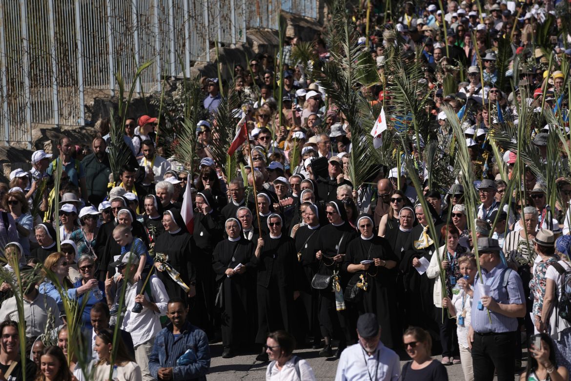 Christians walk in the Palm Sunday procession on the Mount of Olives