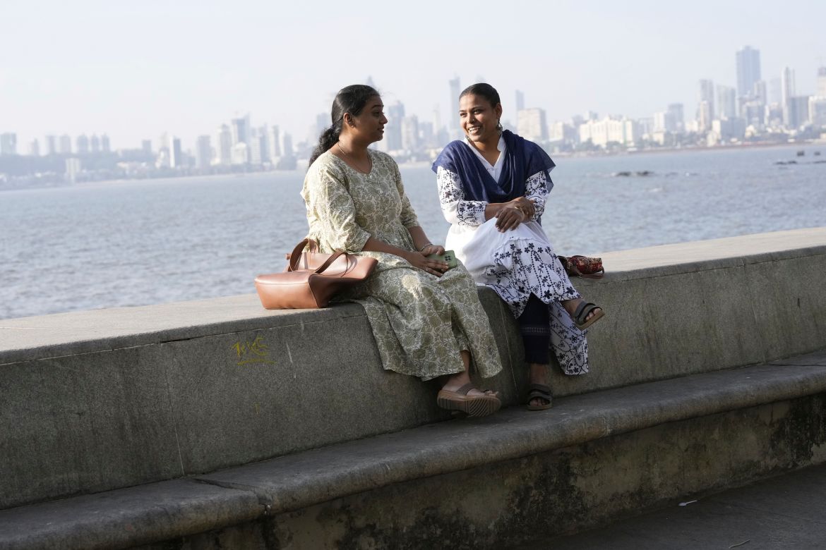 Sunita Sutar, right, speaks with a friend Nirmiti Bhor at Nariman Point in Mumbai,