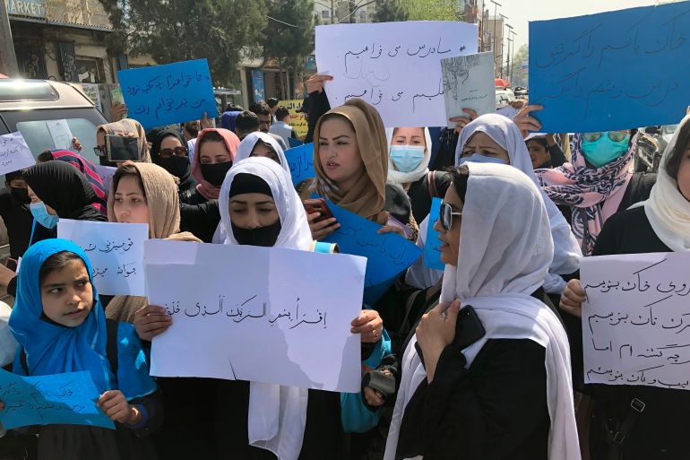Afghan women chant and hold signs of protest during a demonstration in Kabul, Afghanistan