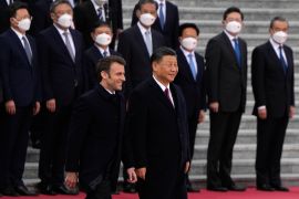 French President Emmanuel Macron, bottom left, walks with Chinese President Xi Jinping during a welcome ceremony held outside the Great Hall of the People in Beijing